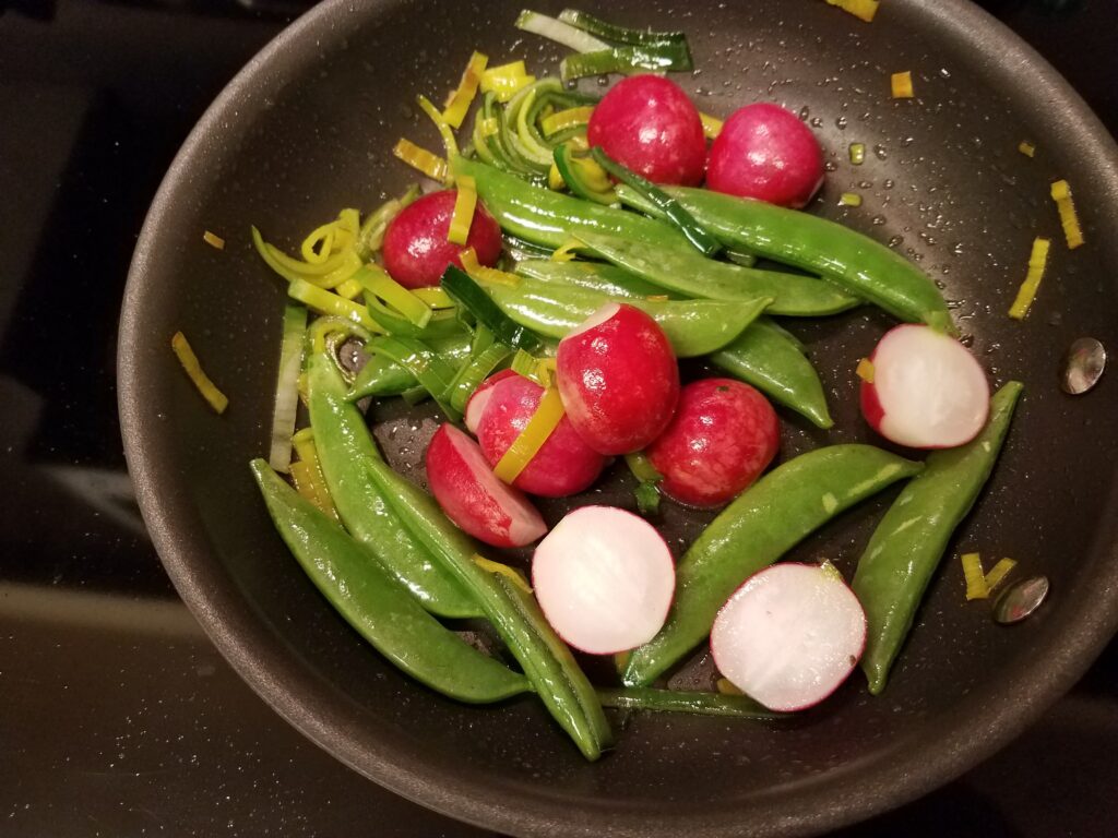 Sauteeing radishes and peas